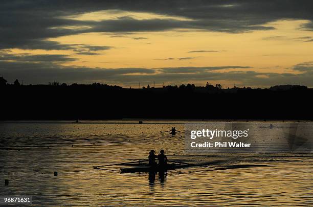 Rowing crews warm up at dawn before the final day of the New Zealand National Rowing Championships at Lake Karapiro on February 20, 2010 in...