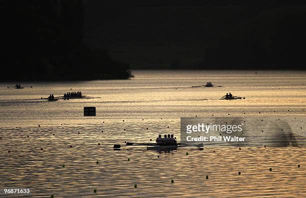 Rowing crews warm up at dawn before the final day of the New Zealand National Rowing Championships at Lake Karapiro on February 20, 2010 in...