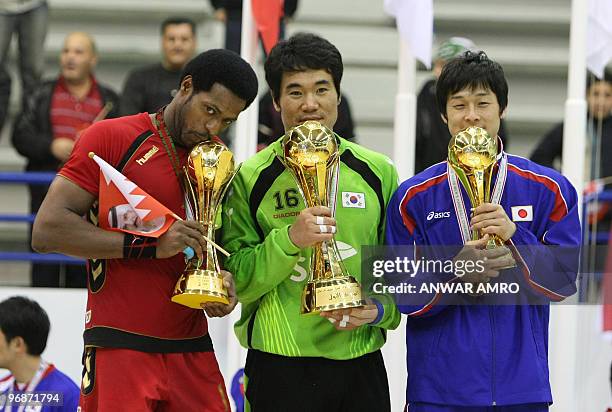 Goalkeeper Il-Koo Kang of South Korea, who won the 2010 Asian handball championship, poses with Bahrain's captain Said Jawhar of the second runners...