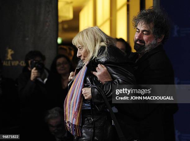 French director Gustave Kervern carries long time Berlinale photographer Erika Rabau during the photo call for the movie "Mammuth" during the 60th...