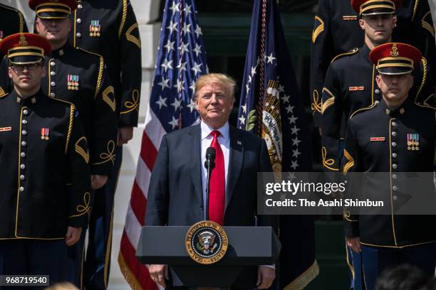 President Donald Trump sings the national anthem with a U.S. Army chorus during a "Celebration of America" event on the south lawn of the White House...