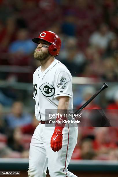 Tucker Barnhart of the Cincinnati Reds walks off of the field after striking out during the sixth inning of the game against the Colorado Rockies at...