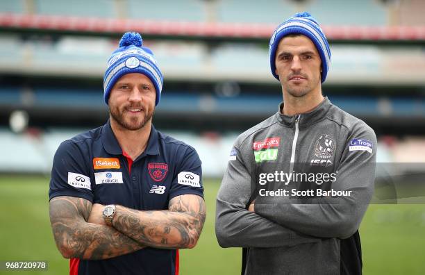 Nathan Jones of the Demons and Scott Pendlebury of the Magpies pose in Big Freeze 4 beanies during an AFL press conference at the Melbourne Cricket...