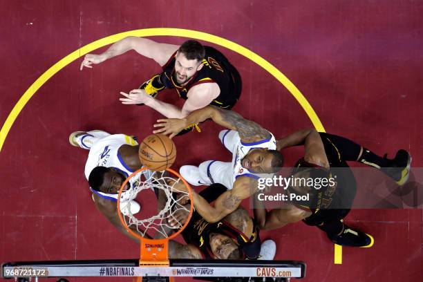 Kevin Love, Tristan Thompson and LeBron James of the Cleveland Cavaliers fight for a rebound with Draymond Green and Andre Iguodala of the Golden...