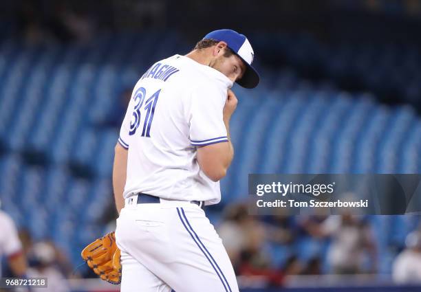 Joe Biagini of the Toronto Blue Jays reacts after giving up a solo home run to Giancarlo Stanton of the New York Yankees in the thirteenth inning...