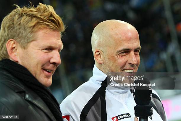 Head coach Michael Frontzeck of Gladbach and former football player Stefan Effenberg smile prior to the Bundesliga match between 1899 Hoffenheim and...