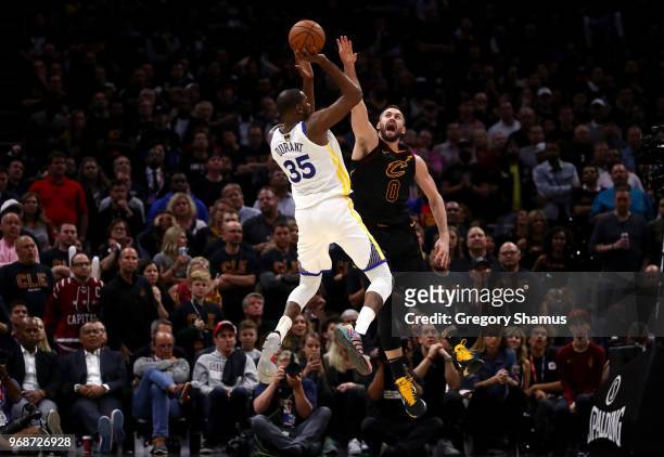 Kevin Durant of the Golden State Warriors attempts a jumper over Kevin Love of the Cleveland Cavaliers in the second half during Game Three of the...