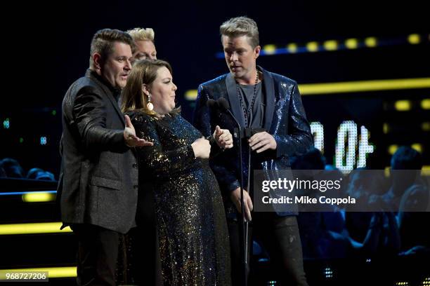 Gary LeVox, Jay DeMarcus, and Joe Don Rooney of Rascal Flatts and Chrissy Metz pose for a selfie onstage at 2018 CMT Music Awards at Bridgestone...