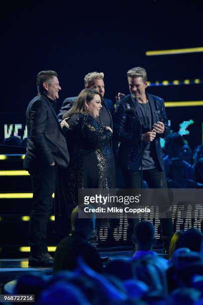 Gary LeVox, Jay DeMarcus, and Joe Don Rooney of Rascal Flatts and Chrissy Metz pose for a selfie onstage at 2018 CMT Music Awards at Bridgestone...