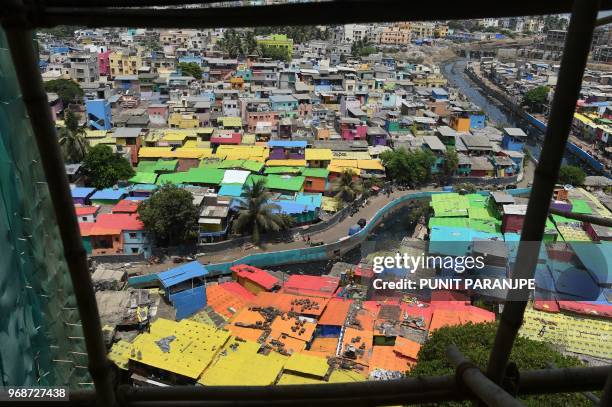 This aerial picture taken on June 2, 2018 shows a view of houses painted in bright colours at a fishing area in Mumbai. Mumbai's slums are getting a...