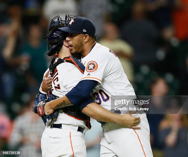 Hector Rondon of the Houston Astros hugs Tim Federowicz after the final out against the Seattle Mariners at Minute Maid Park on June 6, 2018 in...