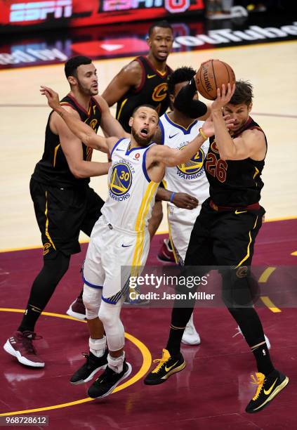 Kyle Korver of the Cleveland Cavaliers and Stephen Curry of the Golden State Warriors battle for a rebound in the fourth quarter during Game Three of...