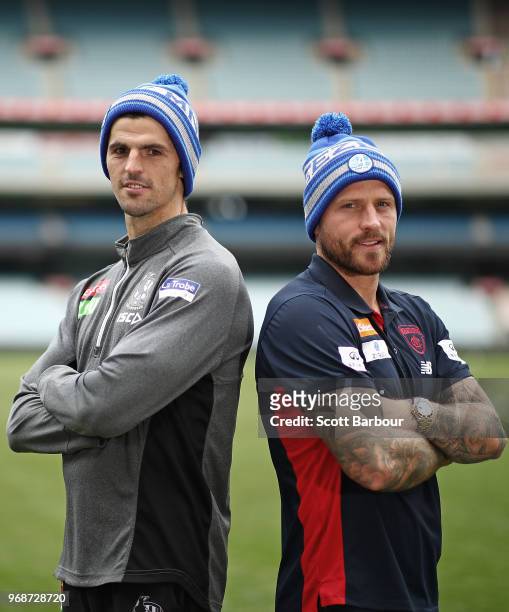 Nathan Jones of the Demons and Scott Pendlebury of the Magpies pose in Big Freeze 4 beanies during an AFL press conference at the Melbourne Cricket...