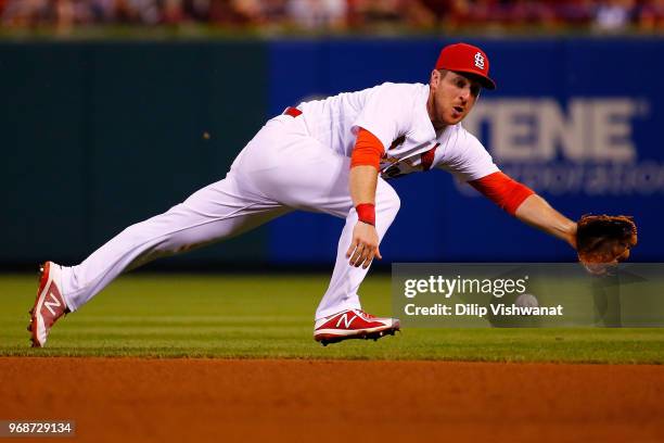 Jedd Gyorko of the St. Louis Cardinals attempts to field a roundball against the Miami Marlins \in the fifth inning at Busch Stadium on June 6, 2018...