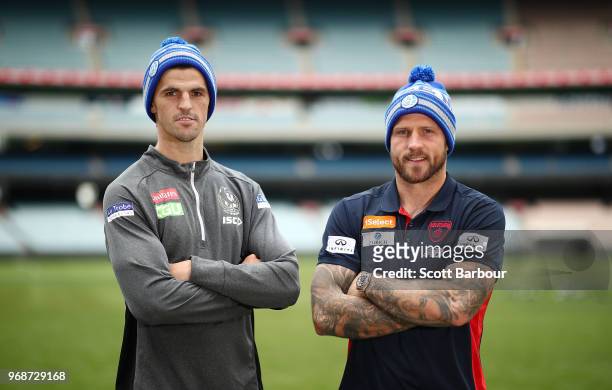 Nathan Jones of the Demons and Scott Pendlebury of the Magpies pose in Big Freeze 4 beanies during an AFL press conference at the Melbourne Cricket...