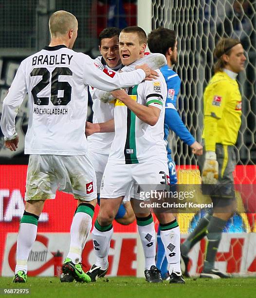 Filip Daems of Gladbach celebrates after scoring his team's first goal with team mates Michael Bradley of Gladbach and Rául Marcelo Bobadilla during...