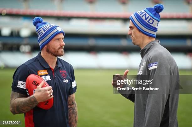 Nathan Jones of the Demons and Scott Pendlebury of the Magpies talk in Big Freeze 4 beanies during an AFL press conference at the Melbourne Cricket...