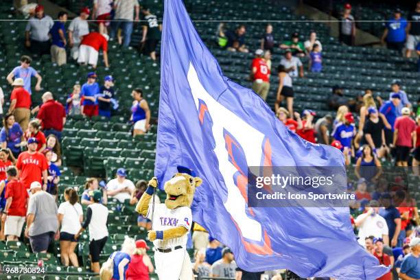 The Texas Rangers mascot Captain runs with a flag after the game between the Texas Rangers and the Oakland Athletics on June 06, 2018 at Globe Life...