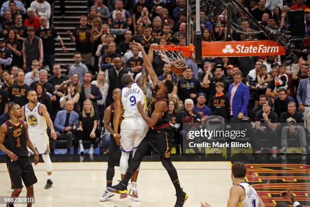 Andre Iguodala of the Golden State Warriors dunks the ball while guarded by Tristan Thompson of the Cleveland Cavaliers in Game Three of the 2018 NBA...