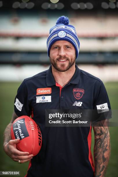 Nathan Jones of the Demons poses in a Big Freeze 4 beanie during an AFL press conference at the Melbourne Cricket Ground on June 7, 2018 in...