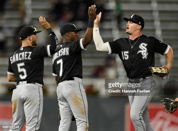 Yolmer Sanchez, Tim Anderson and Adam Engel of the Chicago White Sox celebrate defeating the Minnesota Twins 5-2 after the game on June 6, 2018 at...