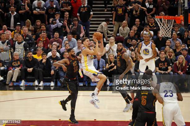 Klay Thompson of the Golden State Warriors drives to the basket and shoots the ball against the Cleveland Cavaliers in Game Three of the 2018 NBA...