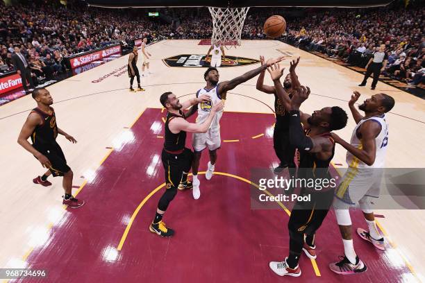 Jordan Bell of the Golden State Warriors battles for a rebound with Kevin Love, Tristan Thompson, and Jeff Green of the Cleveland Cavaliers in the...
