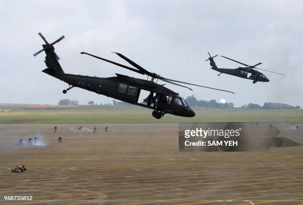 Pair of UH-60 Black Hawk helicopters take part in the Han Kuang drill at the Ching Chuan Kang air force base in Taichung, central Taiwan, on June 7,...