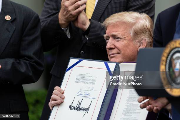 President Donald Trump signs S. 2372, the VA Mission Act of 2018 at a ceremony in the Rose Garden of the White House, on Wednesday, June 6, 2018.