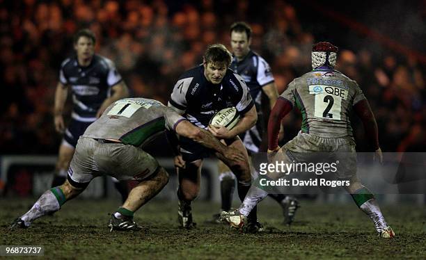 Gavin Kerr of Sale is tackled by Mike MacDonald and Andy Titterrell during the Guinness Premiership match between Sale Sharks and Leeds Carnegie at...