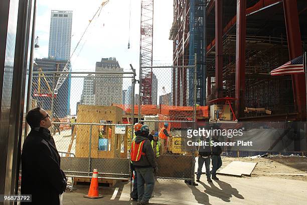 People stand in front of a gate at the World Trade Center site February 19, 2010 in New York City. In a radio interview Friday New York Mayor Michael...