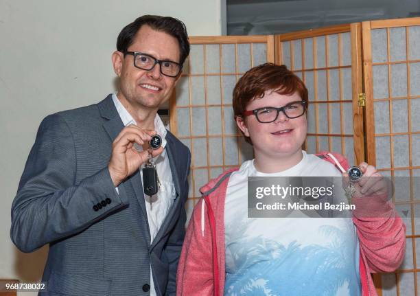 Scott Butler and Grayson Kilpatrick pose with TAP Medallion wearing Moonstar Beauty at Giveback Day at TAP - The Artists Project on June 6, 2018 in...