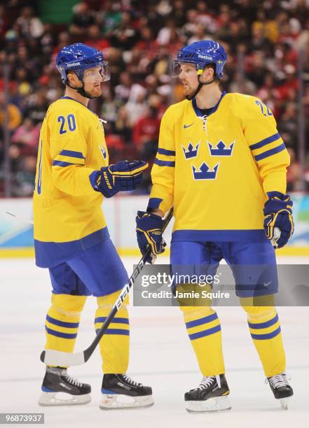 Brothers Henrik Sedin and Daniel Sedin of Sweden talk during the ice hockey men's preliminary game against Belarus on day 8 of the Vancouver 2010...