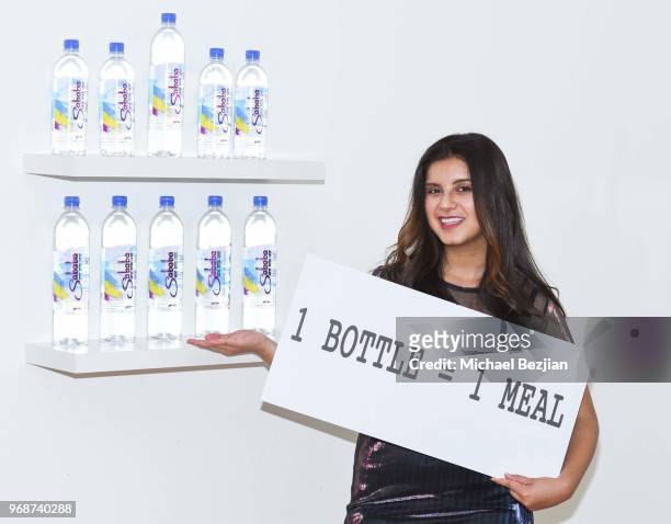 Amber Romero poses with Sababa water at Giveback Day at TAP - The Artists Project on June 6, 2018 in Los Angeles, California.