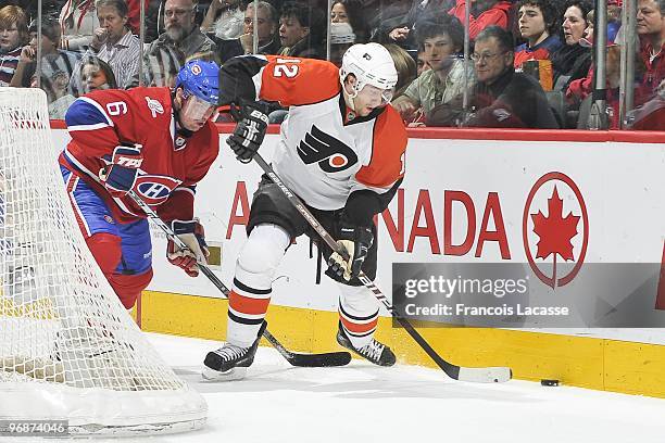 Jaroslav Spacek of the Montreal Canadiens battles for the puck with Simon Gagne of the Philadelphia Flyers during the NHL game on February 13, 2010...