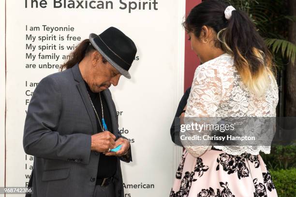 Actor Danny Trejo autographing one of 826LA student's name tags just before the evening program of the 826LA Presents "Tell Me A Story: Untold...