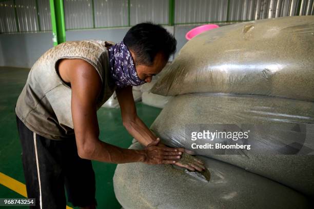 Worker checks a sample of ground kratom at a facility in Kapuas Hulu, West Kalimantan, Indonesia, on Thursday, May 3, 2018. Kratom, a coffee-like...