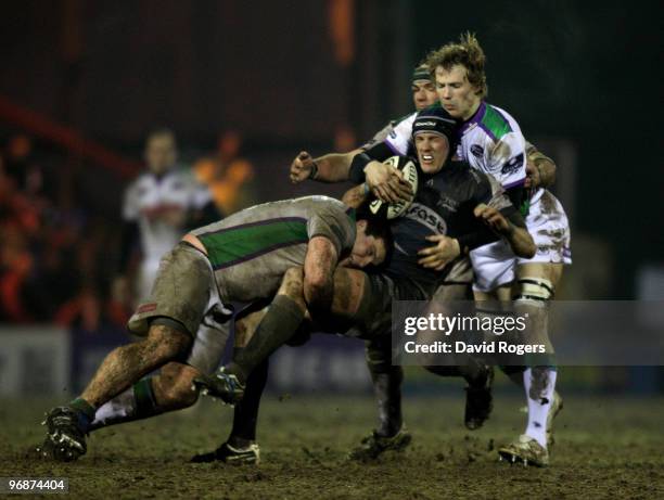 Chris Jones of Sale is tackled by Mike MacDonald and Kearnan Myall during the Guinness Premiership match between Sale Sharks and Leeds Carnegie at...