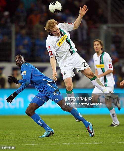 Demba Ba of Hoffenheim and Tobias Levels of Gladbach jump for a header during the Bundesliga match between 1899 Hoffenheim and Borussia...