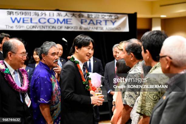 Japanese Prince Akishino greets members of the community during the Nikkei & Japanese Abroad reception in Honolulu, Hawaii, on June 6 during their...