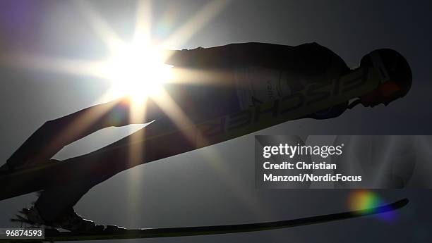 Kamil Stoch of Poland soars off the Long Hill during the qualification round on day 8 of the 2010 Vancouver Winter Olympics at Ski Jumping Stadium on...