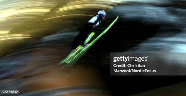 Adam Malysz of Poland soars off the Long Hill during the qualification round on day 8 of the 2010 Vancouver Winter Olympics at Ski Jumping Stadium on...