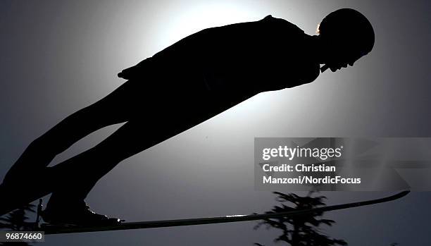 Adam Malysz of Poland soars off the Long Hill during the qualification round on day 8 of the 2010 Vancouver Winter Olympics at Ski Jumping Stadium on...