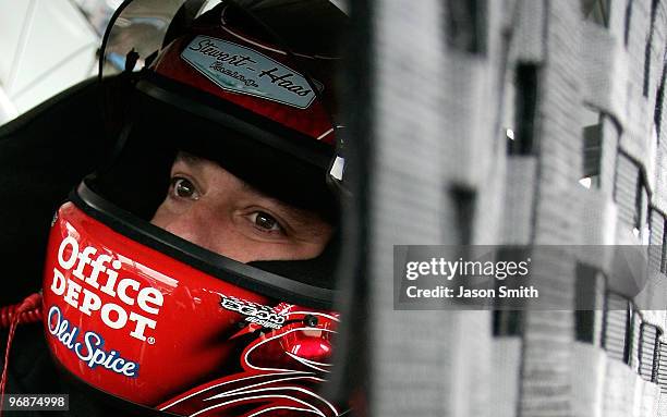 Tony Stewart, driver of the Old Spice Chevrolet, sits in his car during practice for the NASCAR Sprint Cup Series Auto Club 500 at Auto Club Speedway...