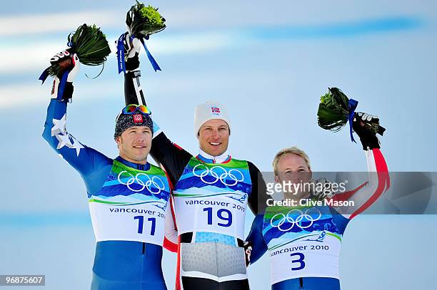 Bode Miller of the United States celebrates winning silver, Aksel Lund Svindal of Norway gold and Andrew Weibrecht of the United States bronze during...