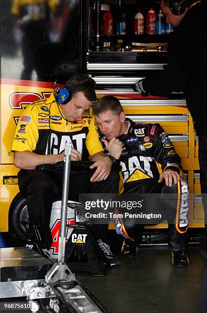 Jeff Burton, driver of the Caterpiller Chevrolet, confers with Crew Chief Todd Berrier in the garage area during practice for the NASCAR Sprint Cup...