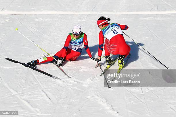 Marit Bjoergen of Norway checks on Kristin Stoermer Steira of Norway at the end of the Ladies' 15 km Pursuit on day 8 of the 2010 Vancouver Winter...