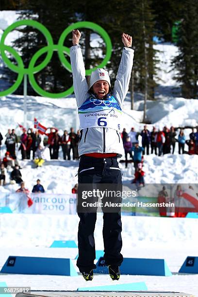 Marit Bjoergen of Norway celebrates her victory in the Ladies' 15 km Pursuit on day 8 of the 2010 Vancouver Winter Olympics at Whistler Olympic Park...