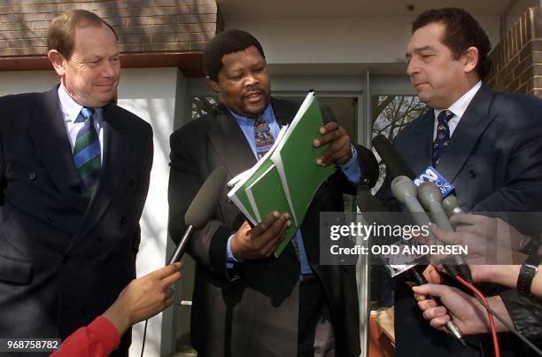 South African sport minister Ngconde Balfour hands the King Commission interim report on alleged match fixing in cricket to South African United...