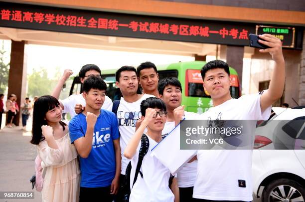 Candidate takes a selfie with classmates before entering an exam site for the National College Entrance Examination on June 7, 2018 in Linyi,...